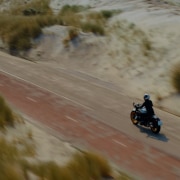A motorcyclist rides his bike on a beautiful country road